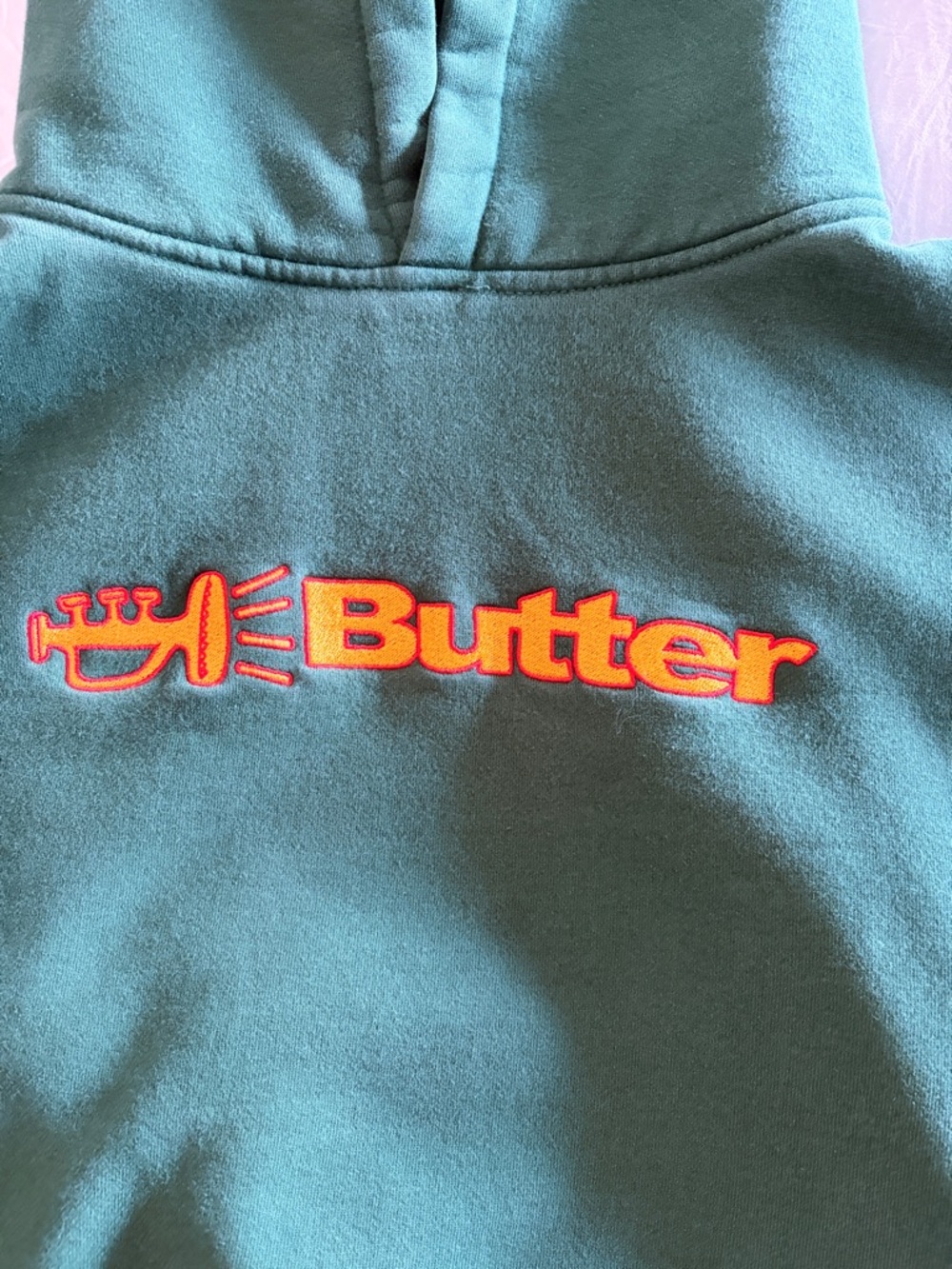 Butter Olive Green Hoodie with Pink Label and Navy Logo